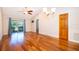Bright living room featuring hardwood floors, a ceiling fan, and sliding glass doors to the outside at 168 Hill St, Casselberry, FL 32707