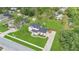 Expansive aerial view of a well-maintained home with lush landscaping, driveway, and spacious green yard at 17657 Windy Pine St, Montverde, FL 34756