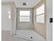 Walk-in shower with sleek fixtures, gray tiling, and natural light from two windows at 17657 Windy Pine St, Montverde, FL 34756