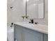 Contemporary bathroom with marble countertop, black faucet, and modern fixtures at 17657 Windy Pine St, Montverde, FL 34756