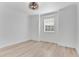 Bright, light-filled bedroom with wood floors and a ceiling light at 17657 Windy Pine St, Montverde, FL 34756