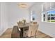 Dining room with a modern table and bench, complemented by a stylish chandelier at 17657 Windy Pine St, Montverde, FL 34756