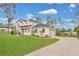 Well-maintained home featuring an attached garage and manicured lawn at 17657 Windy Pine St, Montverde, FL 34756