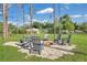Inviting backyard fire pit with chairs, perfect for outdoor gatherings and relaxing evenings at 17657 Windy Pine St, Montverde, FL 34756