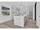 Bright kitchen with a large island, stainless steel appliances, and a view of the backyard at 17657 Windy Pine St, Montverde, FL 34756