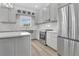 Stylish kitchen featuring stainless steel appliances, modern countertops, and ample cabinet space at 17657 Windy Pine St, Montverde, FL 34756