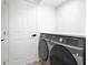 Modern laundry room featuring front-load washer and dryer, and ample storage space at 17657 Windy Pine St, Montverde, FL 34756