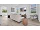 Cozy living room with modern furniture, neutral tones, and plenty of natural light at 17657 Windy Pine St, Montverde, FL 34756