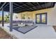 Covered patio featuring an outdoor seating area with a stylish rug and lighting at 17657 Windy Pine St, Montverde, FL 34756