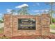 Pines of Montverde community entrance sign, constructed of brick with lush flowerbed at 17657 Windy Pine St, Montverde, FL 34756