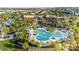 Spectacular aerial view of the community pool and recreation area surrounded by palm trees and lush landscaping at 1836 Sandy Park Trl, Kissimmee, FL 34747