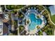 Breathtaking aerial shot of a resort-style pool, surrounded by lush greenery and ample seating areas at 1836 Sandy Park Trl, Kissimmee, FL 34747