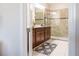 Bathroom featuring a tile shower and dark wood vanity at 1836 Sandy Park Trl, Kissimmee, FL 34747