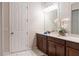 Bathroom with dark cabinets, white countertop, mirror, and tiled floor at 1836 Sandy Park Trl, Kissimmee, FL 34747