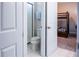 Bright bathroom featuring a toilet, shower, and sink with white tile, offering a clean and functional space at 1836 Sandy Park Trl, Kissimmee, FL 34747
