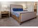 Bedroom featuring a upholstered bed, two side tables, and lamps at 1836 Sandy Park Trl, Kissimmee, FL 34747