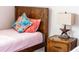 Close up of the bedroom showing decorative pillows and a lamp on the wooden nightstand at 1836 Sandy Park Trl, Kissimmee, FL 34747