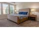 Bedroom with natural light, upholstered bed, two side tables, and lamps at 1836 Sandy Park Trl, Kissimmee, FL 34747