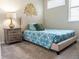 Cozy bedroom features a comfortable bed, nightstand with lamp, and a decorative wall art for a relaxing retreat at 1836 Sandy Park Trl, Kissimmee, FL 34747