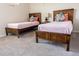 Bedroom featuring two beds, a nightstand, and stylish decor, providing a cozy and inviting space for restful nights at 1836 Sandy Park Trl, Kissimmee, FL 34747
