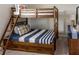 Charming bunk bed in a ' room, complemented by a nautical-themed pillow and a matching dresser at 1836 Sandy Park Trl, Kissimmee, FL 34747