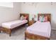 Charming bedroom with two twin beds, colorful accents, and soft lighting at 1836 Sandy Park Trl, Kissimmee, FL 34747