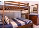 Comfortable bedroom with bunkbeds, dresser and décor, creating a cozy and functional space for relaxation and sleep at 1836 Sandy Park Trl, Kissimmee, FL 34747