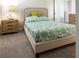 Comfortable bedroom with plush carpet, soft headboard and calming blue and green comforter at 1836 Sandy Park Trl, Kissimmee, FL 34747