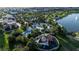 Aerial view of a community pool with a splashpad and playground, nestled in a lush, tropical landscape at 1836 Sandy Park Trl, Kissimmee, FL 34747