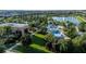 Aerial view of a tropical community pool, splash pad, and clubhouse near a scenic lake at 1836 Sandy Park Trl, Kissimmee, FL 34747