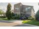 Modern two-story home with black car, a stone facade, manicured lawn, and attached two car garage at 1836 Sandy Park Trl, Kissimmee, FL 34747