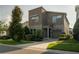 Modern two-story home with a stone facade, well-manicured lawn, and attached two car garage at 1836 Sandy Park Trl, Kissimmee, FL 34747