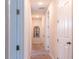 Hallway with multiple doors, neutral paint and plush carpet at 1836 Sandy Park Trl, Kissimmee, FL 34747