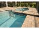 In ground hot tub with pool and a screened enclosure, providing an ideal outdoor retreat at 1836 Sandy Park Trl, Kissimmee, FL 34747
