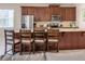 Open-concept kitchen with modern stainless appliances, center island with barstool seating, and easy access to the living room at 1836 Sandy Park Trl, Kissimmee, FL 34747
