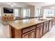 Open-concept kitchen with granite countertops, a large island, stainless steel appliances, and seamless flow to the living area at 1836 Sandy Park Trl, Kissimmee, FL 34747