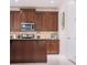 Stylish kitchen boasts rich wood cabinets, stainless steel appliances, and neutral countertops, exuding warmth and functionality at 1836 Sandy Park Trl, Kissimmee, FL 34747