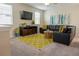 Comfortable living room with contemporary decor, large window and decorative green rug at 1836 Sandy Park Trl, Kissimmee, FL 34747