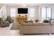 Bright living area with a sectional sofa, stylish decor, and a TV for entertainment at 1836 Sandy Park Trl, Kissimmee, FL 34747