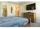 Comfortable main bedroom with TV, ensuite bathroom and calming neutral paint at 1836 Sandy Park Trl, Kissimmee, FL 34747
