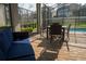 Inviting patio with cozy blue seating, table and chairs surrounded by a screened enclosure offering a relaxed outdoor space at 1836 Sandy Park Trl, Kissimmee, FL 34747