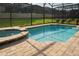 Stunning pool and spa surrounded by lush landscaping, perfect for enjoying the outdoors at 1836 Sandy Park Trl, Kissimmee, FL 34747