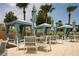 Tranquil poolside cabanas offering shade and comfort by the pool, amidst lush tropical palms at 1836 Sandy Park Trl, Kissimmee, FL 34747