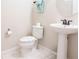 Powder room featuring a pedestal sink and toilet at 1836 Sandy Park Trl, Kissimmee, FL 34747