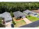 An aerial view of houses with lush trees, driveways, and well-maintained lawns at 2085 Friar Tuck Ln, Orange City, FL 32763