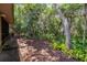 A lush backyard with beautiful landscaping and a secure black fence at 2085 Friar Tuck Ln, Orange City, FL 32763