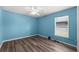 Bedroom with wood-look floors, a window, and an abundance of natural light at 2085 Friar Tuck Ln, Orange City, FL 32763