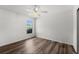 Bright bedroom with hardwood floors, a window, and white walls at 2085 Friar Tuck Ln, Orange City, FL 32763