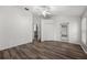 Well-lit bedroom with wood-look floors, closet, and adjacent doorway at 2085 Friar Tuck Ln, Orange City, FL 32763