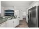 Kitchen with stainless steel refrigerator, white cabinets, laminate floors, and ample counter space at 2085 Friar Tuck Ln, Orange City, FL 32763